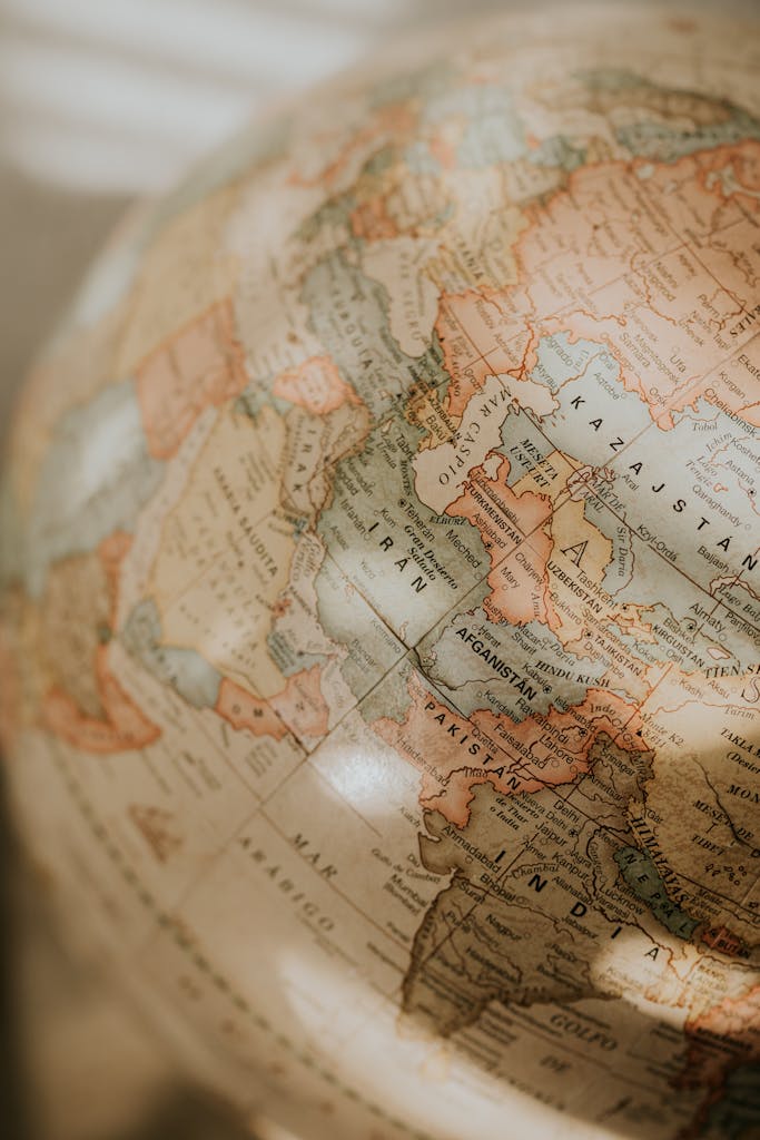 Close-up of a vintage globe focusing on the Middle East with warm tones and detailed cartography.